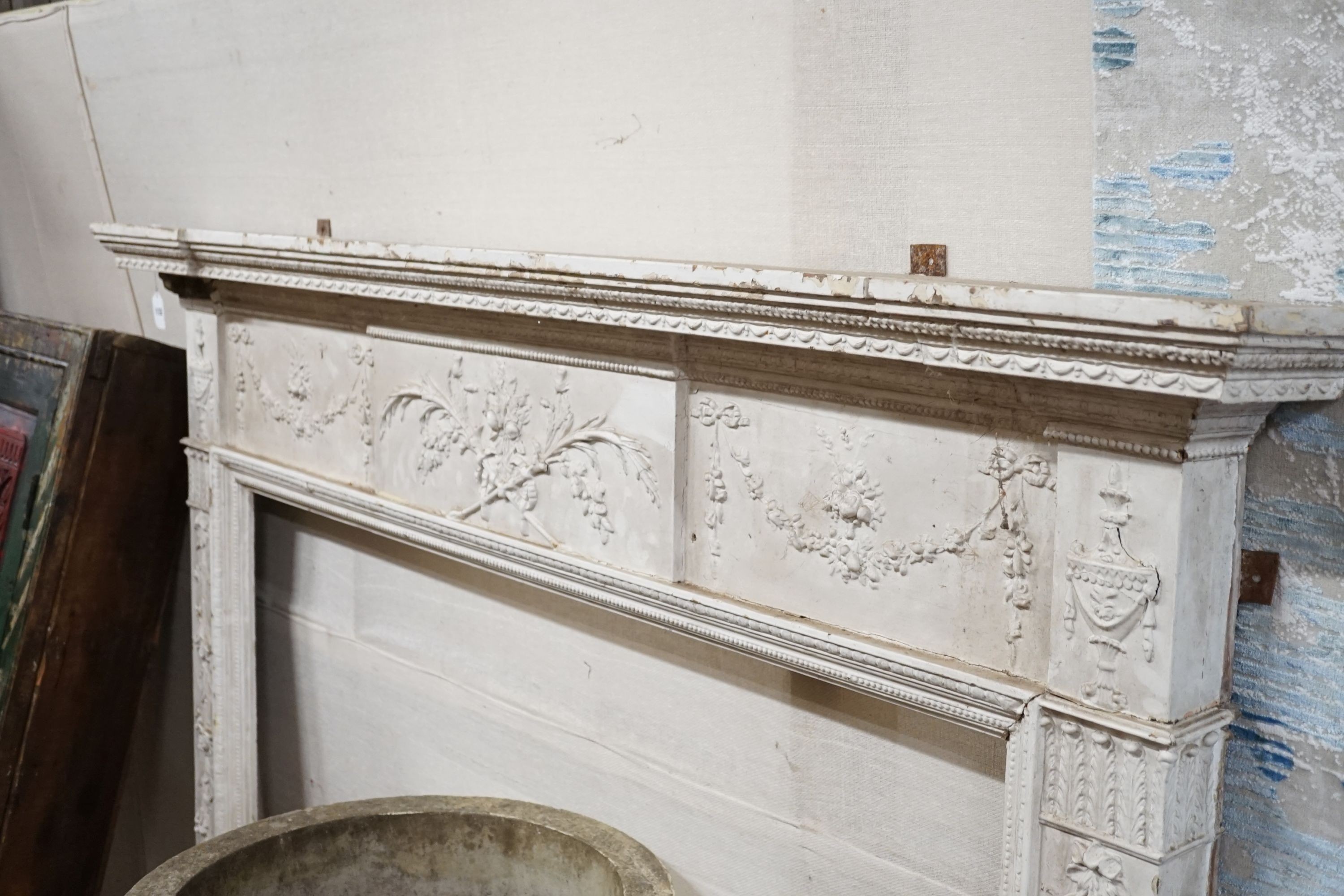 An Edwardian white painted gesso and pine fire surround, width 183cm, height 145cm, aperture width 131cm, height 108cm